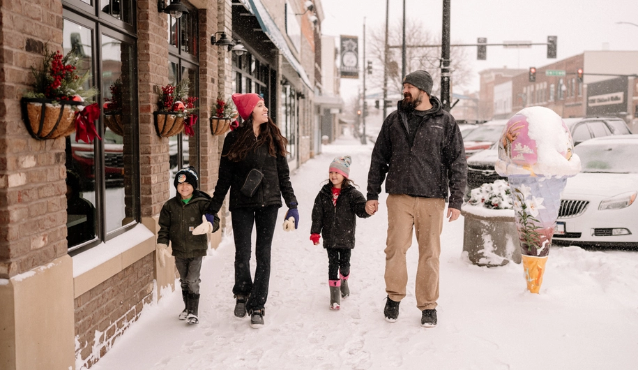 Family walking downtown Le Mars in a beautiful snow.